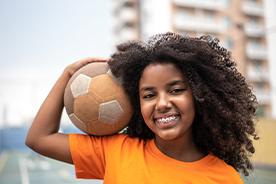 Girl holding soccer ball